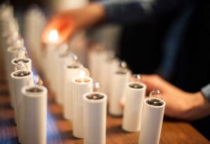 Students lighting a candle at church
